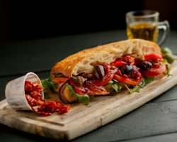 Fresh Italian sandwich with olives and tomatoes in a Manchester cafe.